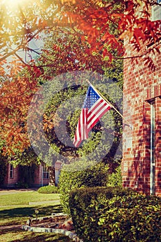 American flag in front of a brick home