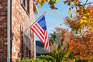 American flag in front of a brick home