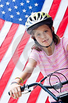 American flag and girl on bike