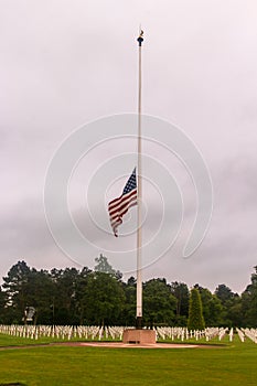 American flag half-mast at WW2 cemetery