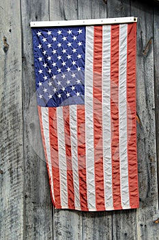 American flag hanging on gray barn wood