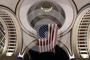 American flag hanging at night from the doom ceiling in Boston Harbor