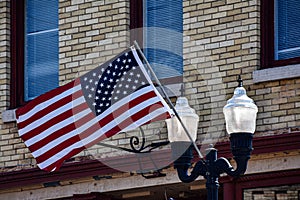 American Flag Hanging From Old Lightpost