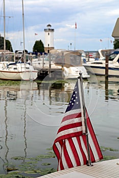 American Flag in Harbor with Boats and Lighthouse