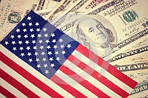 American flag on hundred dollar bill background. Money, cash background. Financial concept. Vintage, retro look.