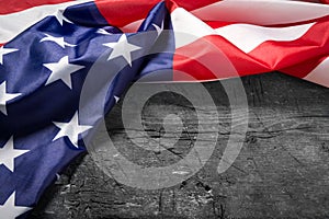 American flag lying on old wooden board