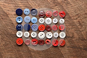 An American flag made with sewing buttons on wood