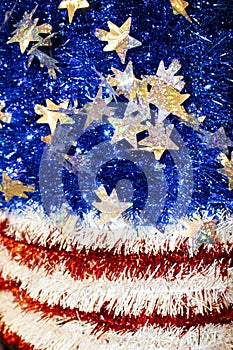 American Flag motif in red white and blue tinsel with sparkly stars with a bokeh blur effect - background or design element