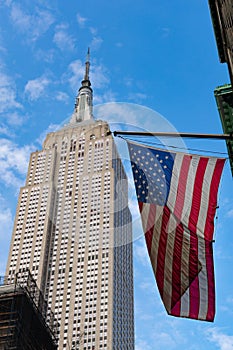 An American Flag next to The Empire State Building in New York City