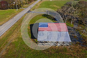 An American Flag  Painted On A Barn Near A Country Road