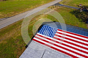 An American Flag  Painted On A Barn Near A Country Road