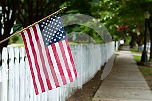 American flag on a picket fence.