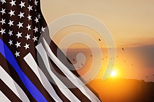 American flag with police support symbol Thin blue line on sunset sky.