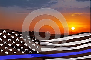 American flag with police support symbol Thin blue line on sunset sky.