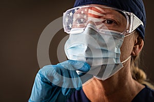 American Flag Reflecting on Female Medical Worker Wearing Protective Face Mask and Goggles