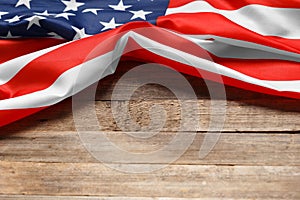 American flag on a rustic wooden background, copy space. Symbol of independence, patriotism