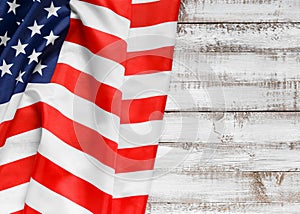 American flag on a rustic wooden background, top view, copy space. Symbol of independence, patriotism