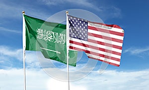 American flag and Saudi Arabia flag on cloudy sky.