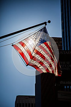 American flag silhouetted against the sun