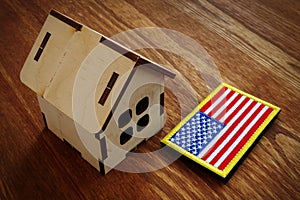 American flag and small house. VA mortgage loan concept photo