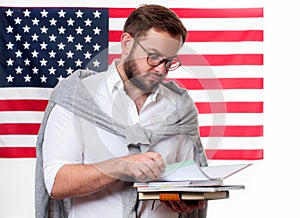 American flag. Smiling young man on United States flag background.