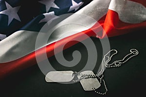 American flag and soldiers tags on wooden background.Veterans Day Concept.