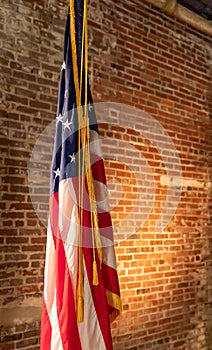 American Flag on Stand, against old brick wall