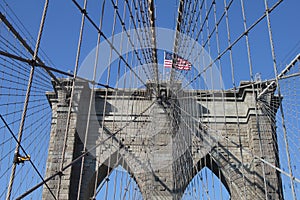 American flag on top of the famous Brooklyn Bridge