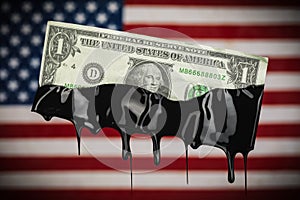 American flag with US dollar bill dripping with oil showing the high cost of gas at the pump or the dependency on fossil fuels