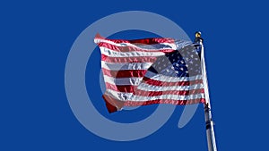 American Flag Waving Against A Clear Blue Sky