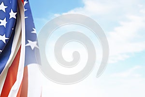 American flag waving in the air with a blue sky background