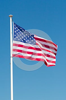 American flag waving in a blue sky