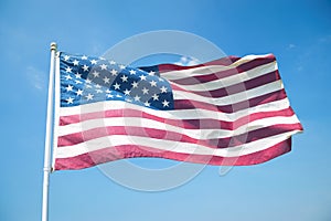 American Flag Waving in Bright Blue Sky