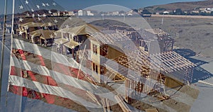 American Flag Waving With Drone Aerial View of New Home Construction Site Background