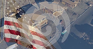 American flag waving with drone aerial view of new home construction site background