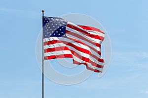 American Flag waving on pole with vibrant colored stars and stripes