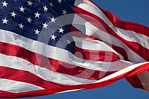 American Flag Waving In Wind Against a Deep Blue Sky