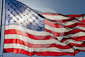 American Flag Waving In Wind Against a Deep Blue Sky