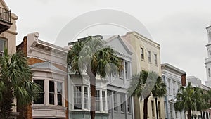 American flag on white church background. Colorful old Houses. Beautiful roofs. Clock on the church towers