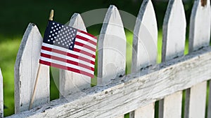 American Flag on white picket fence