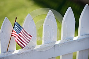 American Flag on white picket fence