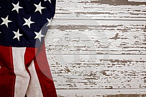 A crumpled American flag on a white plank background with copy space for holidays etc.