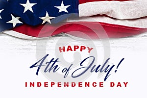 American flag on a white worn wooden background with greeting