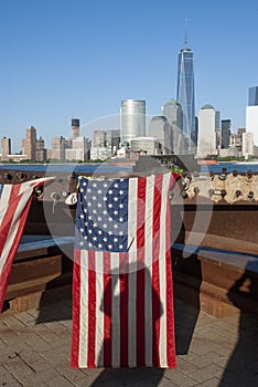 American Flags at 9/11 Memorial on Hudson River with view to Manhattan Skyline and Financial District