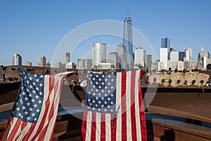 American Flags at 9/11 Memorial on Hudson River with view to Manhattan Skyline and Financial District