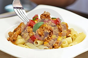 American food. Pasta alla genovese. Pasta with corn, fried meat and sauce