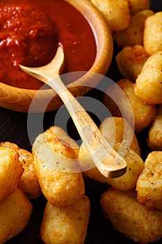 American food: tater tots and ketchup close-up. Vertical