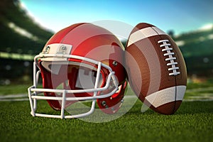 American football ball and helmet on the grass of football arena or stadium