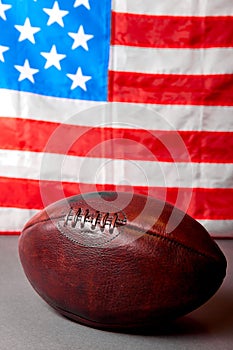 American football ball and old glory flag