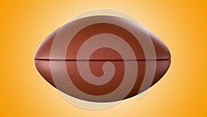 American football ball rotating in motion on orange screen. Looped American football 3d Animation. 3d. 4K